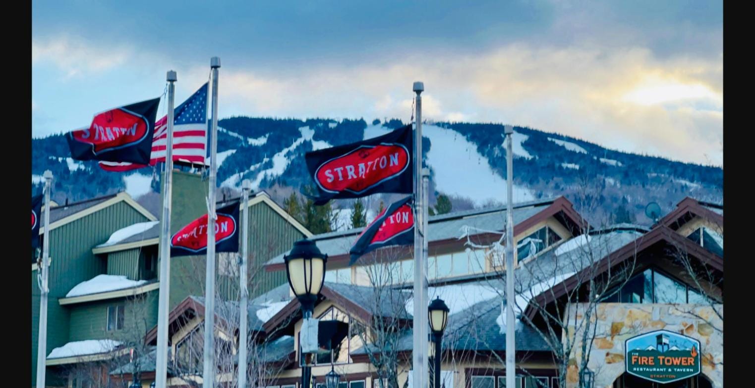 Stratton Mountain base village with flags and Fire Tower restaurant