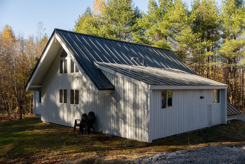 Classic A-frame exterior surrounded by trees