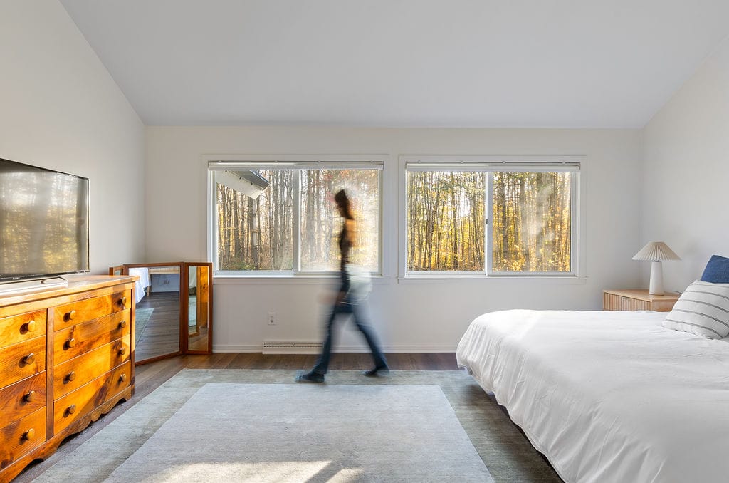 Primary bedroom with forest views